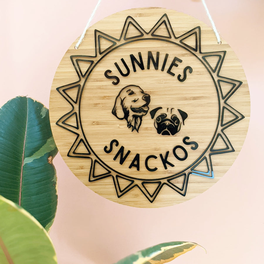 Bamboo sign hanging from cord with black dog logo