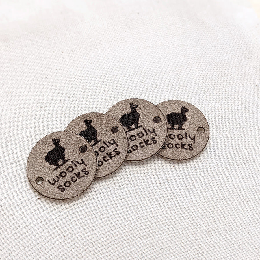 Macro suede circle tags in golden oat