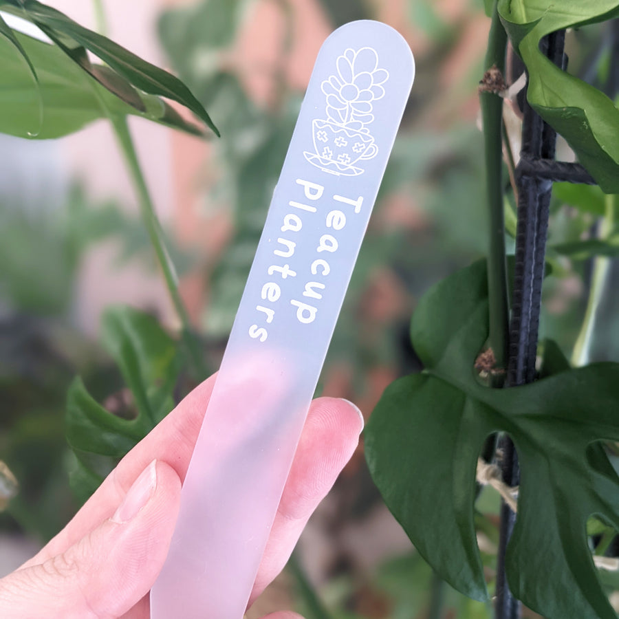 Frosted acrylic planter stake with a custom logo